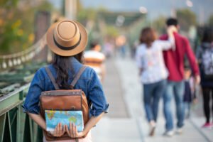 female tourists on hand have a happy travel map.